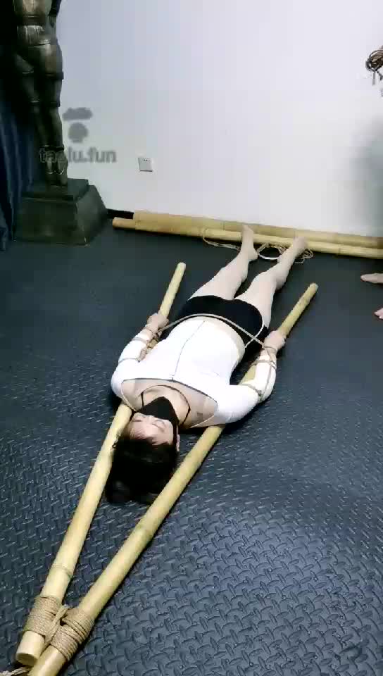 HD, female body with bamboo sticks and hemp rope
