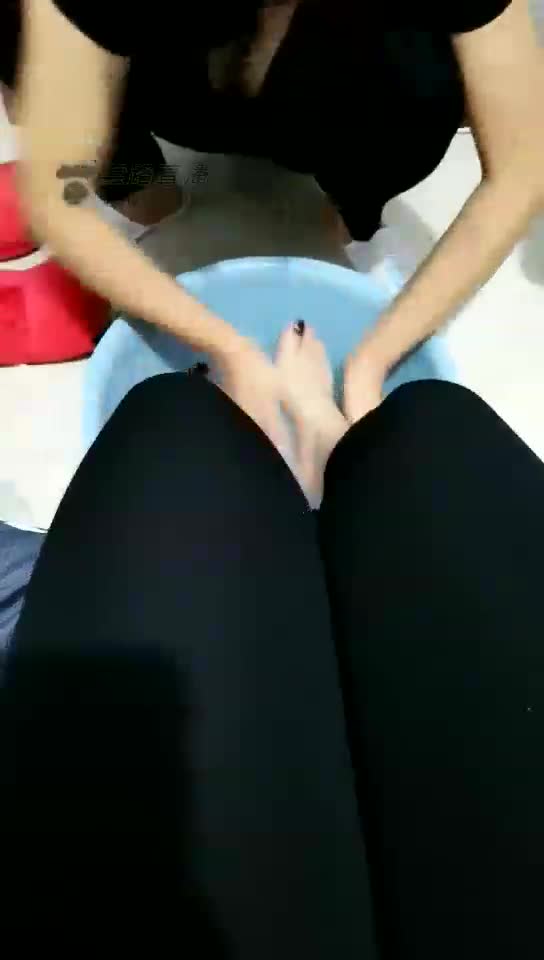 Female slave waits on her master to wash her feet
